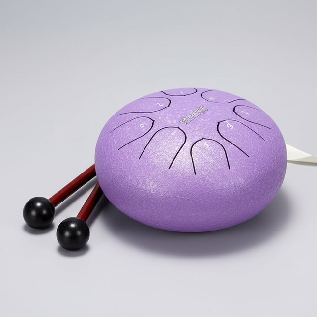 Tongue drum violet Sonora-Mundi avec mailloches sur fond gris clair