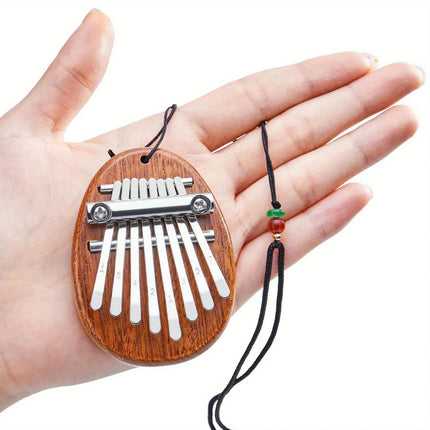 Mini kalimba en bois Sonora-Mundi, porte-clés instrument de musique africain, tenu en main