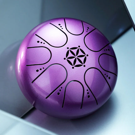 Handpan violet métallique Sonora-Mundi, motif floral découpé, posé sur fond argenté