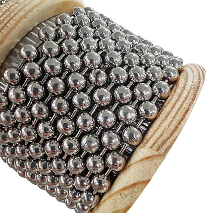 Instrument musical Sonora-Mundi, surface en métal argenté avec poignées en bois.